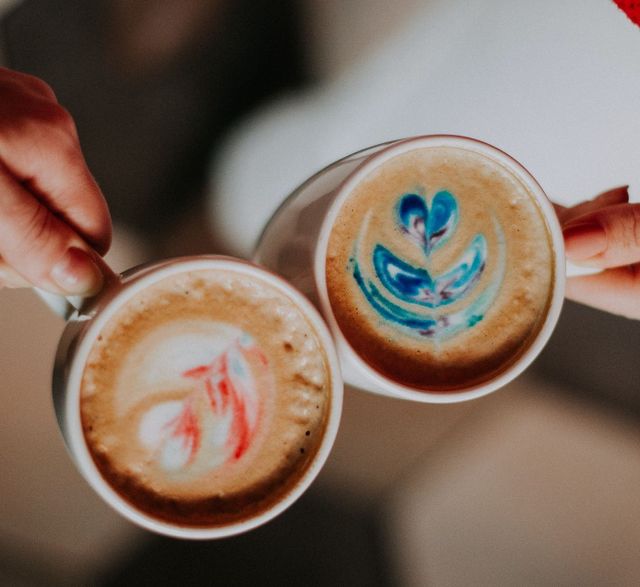 2 cups of coffee in hands